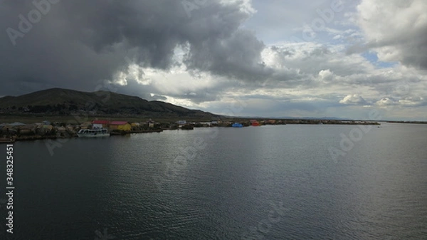 Fototapeta Lake Titicaca in Puno in Peru, view from drone and floating islands of the Uros people in the background