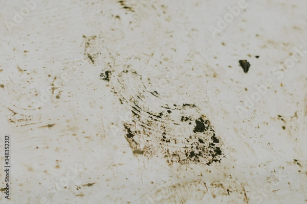 Fototapeta Black wet footprints over dirty tiles 