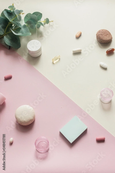 Fototapeta A close-up view of various pills and macaroni on pink and yellow background. Dietary supplements and vitamins. Medical, pharmacy and health care concept. Empty place for text or logo. Top down view.