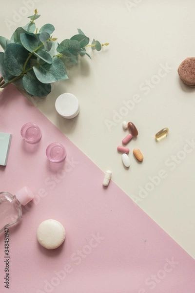 Fototapeta A close-up top view of various pills and macaroni on yellow and pink background. Dietary supplements and vitamins. Medical, pharmacy and health care concept. Copy place for text or logo. Pill box.