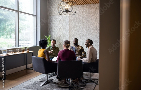 Fototapeta Diverse businesspeople having a casual meeting together in an of