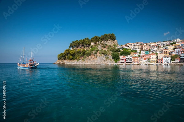 Fototapeta the city of Parga, by the mediterranean sea, with it's houses and boats in the pier