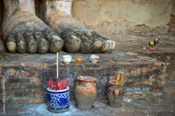 Obraz offerings and feet of Buddha statue in Sukhothai, Thailand