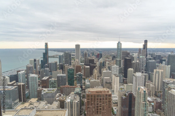 Fototapeta aerial view of chicago, showing some of the tallest buildings in the city. You can also see the lake and in the background you can see the sunset
