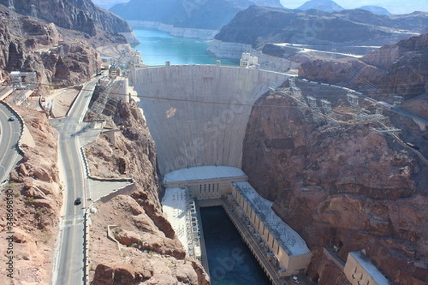 Fototapeta Infrastructure of a dam with a beautiful blue sky and totally clear