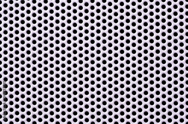 Fototapeta Close up view of white aluminum mesh. round holes in the iron grid. Perforated steel mesh texture with small holes