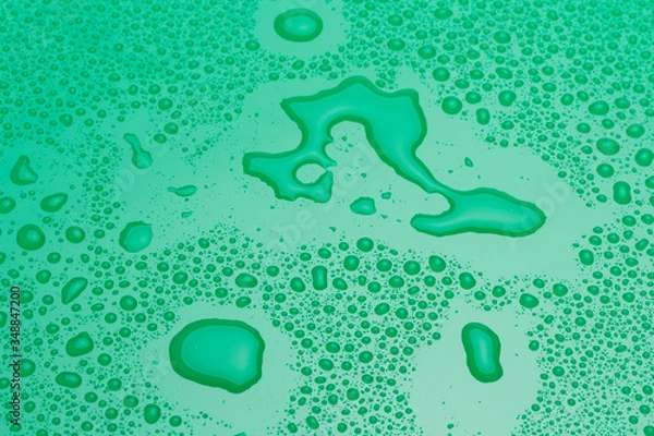 Obraz Drops of water on a green surface