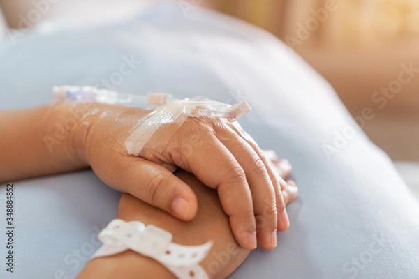 Fototapeta Social distancing outbreak Covid-19, Hands Asian Patients with medical drip intravenous needle, saline Iv drip, give salt water to body. Intravenous therapy-IV is therapy delivers fluids directly vein