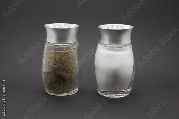 Obraz Condiments. Salt and Pepper on a black background