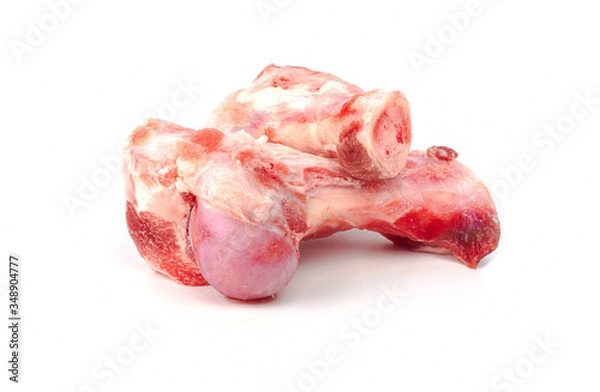 Fototapeta Close up frozen fresh pork bones with red meat stuck To be used for making pork bone broth on a white background
