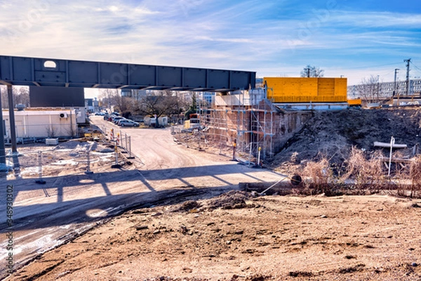 Fototapeta Construction site of a bridge, scaffolding and cladding, blue sky