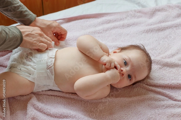 Fototapeta Top View Mom Changing Diaper To Baby