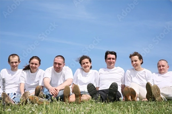 Fototapeta Group of friends in white T-shorts have a rest on a grass