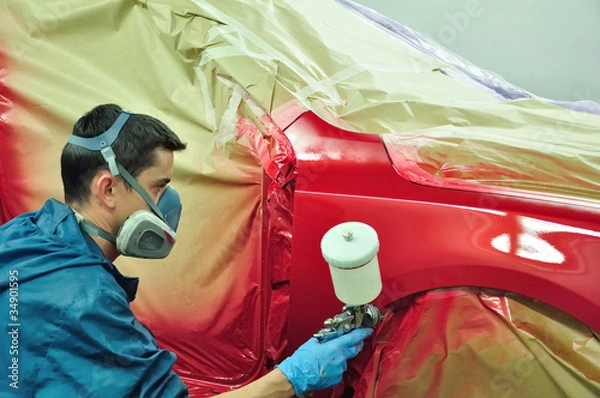 Obraz Worker painting a car.