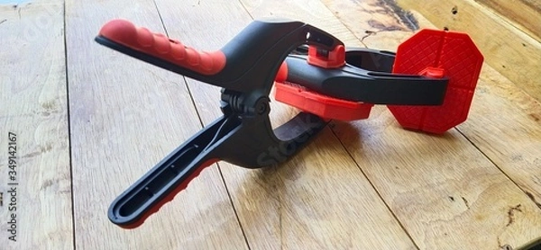 Obraz A spring clamp made of nylon resin on the table wooden