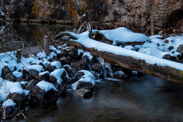Fototapeta A little waterfall in the middle of Carpathians captured in the middle of winter. It is located at Red Lake in Romania