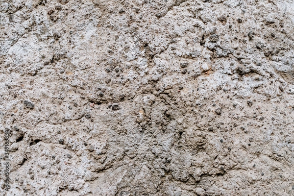 Fototapeta Old dirty wall uneven texture. Vintage or grungy white background of natural cement & stone texture as retro pattern wall. It is a concept design. Metaphor banner, material aged, rust or construction.