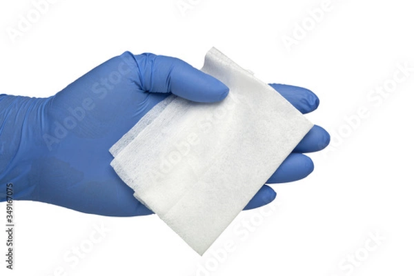 Obraz Gloved hand holding an antibacterial cleansing wipe
