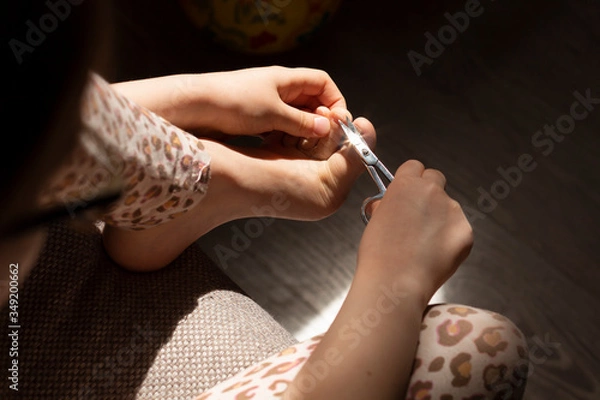 Obraz Pedicure beauty at home. Cares foot nails. Foot fingernails cutting with scissors.