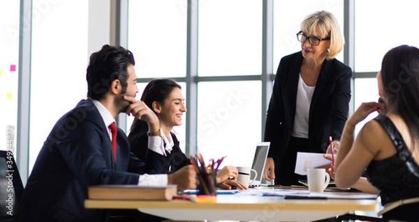 Fototapeta Multiethnic Business people busy working together on business project in modern office. Brainstorming, analyze and discussion concept.