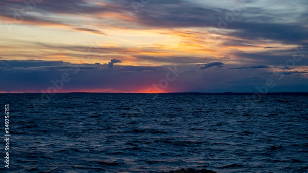 Obraz Sunset on the beach, dramatic sky and clouds.