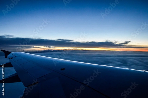Obraz Sunset view over the clouds from an airplane