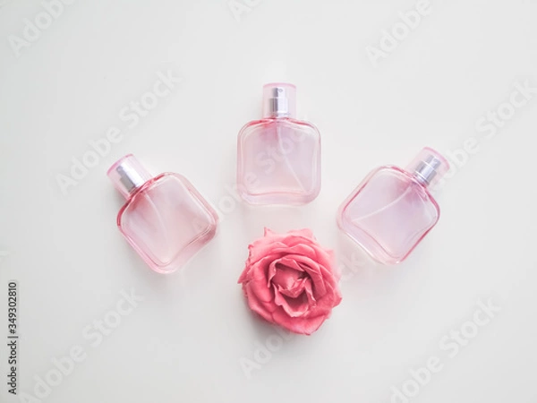 Fototapeta  Set of colored cosmetic bottles, ampoules, tubes, cans on a white background. Pink bottles with flowers, aroma concept
