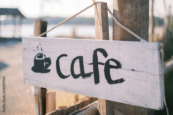 Fototapeta Cafe sign and billboard with rope hanging on the wood post