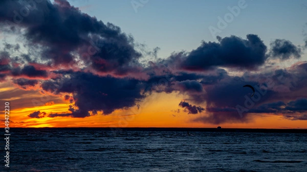 Obraz Sunset on the beach, waves, dramatic sky, dramatic clouds.