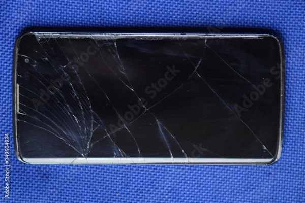 Fototapeta Phone with a broken touch screen. Smart background.