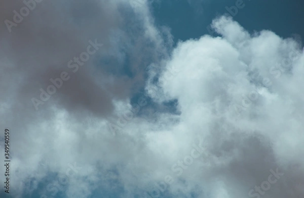 Obraz Fluffy clouds cover the summer blue sky
