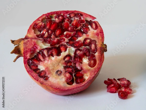 Fototapeta fresh pomegranate with seeds on white background