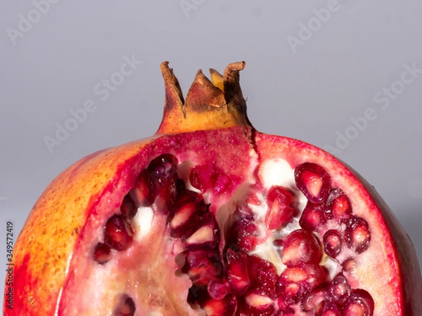 Fototapeta top part of a pomegranate on grey background