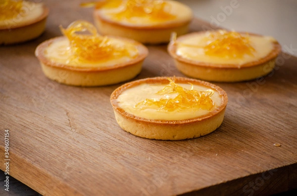 Obraz lemon tart on a wooden cutting board close up