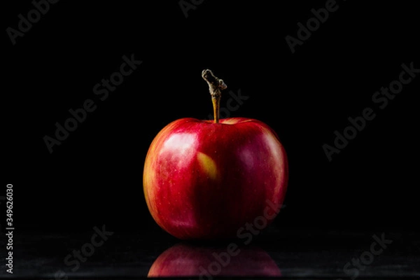 Obraz Red apple on a black background
