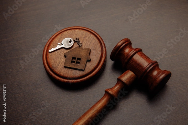 Obraz Judge gavel and key chain in shape of two splitted part of house on wooden background. Concept of real estate auction or dividing house when divorce, division of property, real estate, law system.