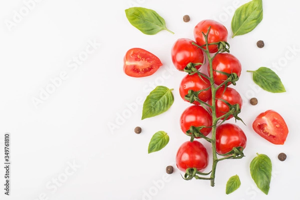 Fototapeta Top above overhead view photo of a bunch of cherry tomatoes surrounded with peppercorns and basil leaves isolated on white background