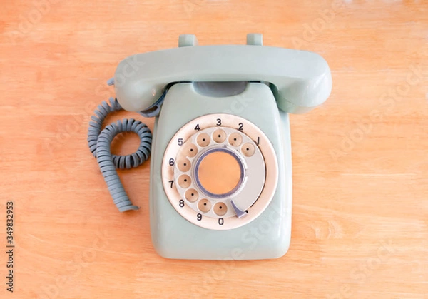 Obraz Old broken green rotary phone on wooden background. selective focus, retro and vintage style