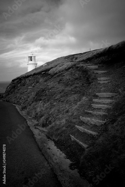 Obraz Lighthouse, looking out to sea, black and white