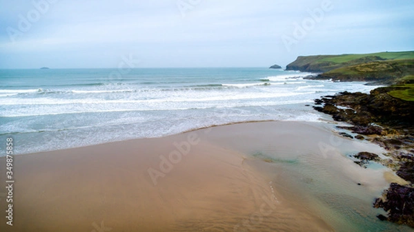 Fototapeta Beach scene, waves and sand, Polzeath, Pentire point, UK