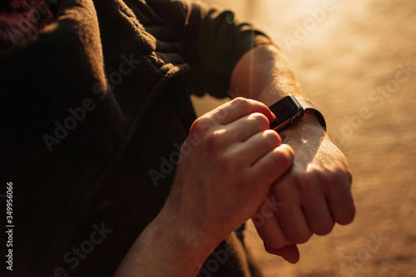 Obraz Man looking at his smartwatch in the city. Business concept.