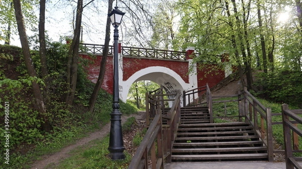 Fototapeta wooden stairs heading to park arch