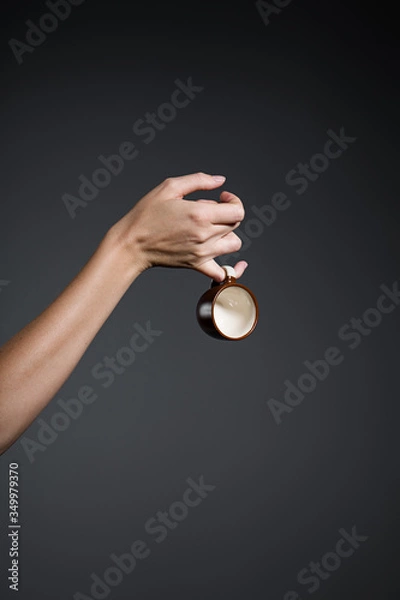 Obraz Empty cup hanging on finger
