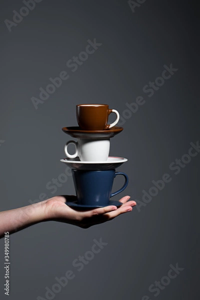 Obraz Hand holding stack of coffee cups