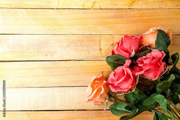 Fototapeta Handmade roses lie on a wooden background. Background layout with free text space.
