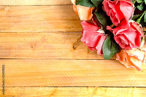 Fototapeta Handmade roses lie on a wooden background. Background layout with free text space.
