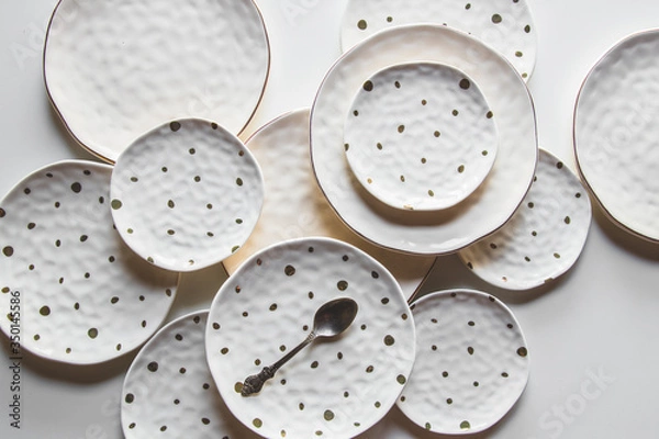 Fototapeta Beautiful plates on a white background with cotton. Beautiful layout