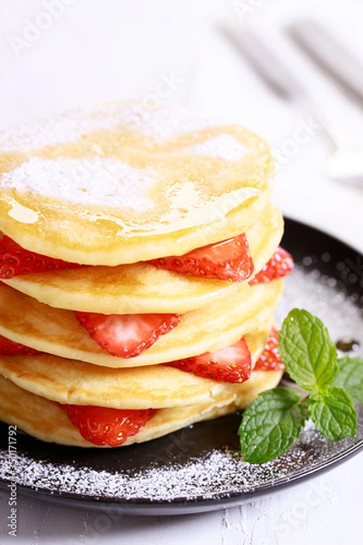 Fototapeta Pancakes with fresh strawberries and maple syrup