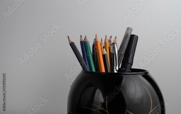 Fototapeta Set of colored pencils in the black vase isolated on white background design, pattern, school, office, art, paper, wooden, pencil, group