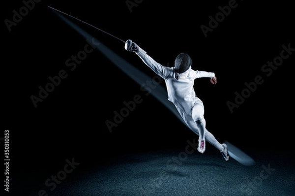 Obraz The fencer moves forward with a sword in his hand. Sport concept.